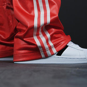Adidas womans red pants white stripes close up ankle shot