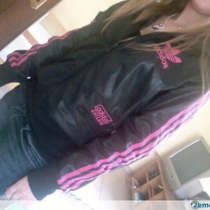 Adidas womans black jacket pink trim tilted angle shot