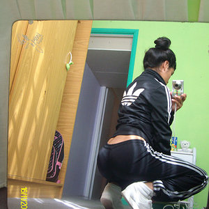 Adidas womans black shiny track suit angled rear shot