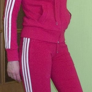 Adidas womans red track suit side pocket pose side lean