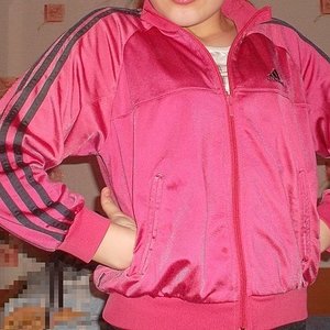 Adidas womans full pink jacket with black trim pocket pose
