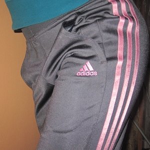 Adidas womans grey pants with pink trim close angle logo shot blue top
