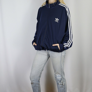 blonde in navy adidas firebird jacket