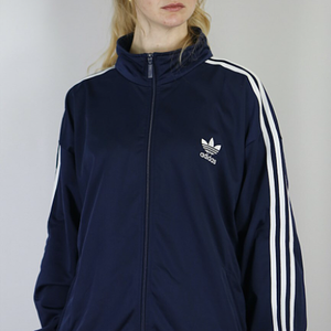blonde in navy adidas firebird jacket