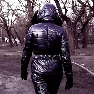 Winter walks in ski overalls. Walking around the city in a space suit - winter overalls and gas mask