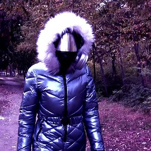 Walking in autumn park in spacesuit, shiny overalls + gas mask - which symbolize future + progress