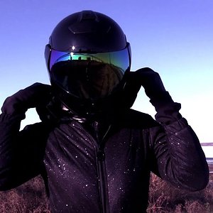 STUDY OF ABANDONED RUINS IN A "STAR" SHINING GLITTER SKI OVERALL WITH BELT AND HOOD + MOTO-HELMET.