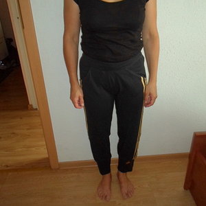 Adidas womans black pants no sleeve black top barefoot front