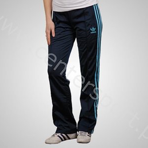 Adidas womans pants with light blue stripes knee pose
