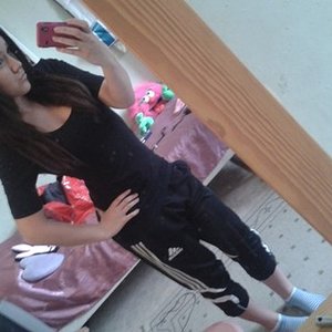 Adidas womens black pants with white trim front tilted shot