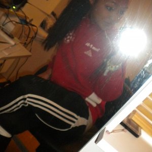 Adidas womens black pants with white trim sitting angle