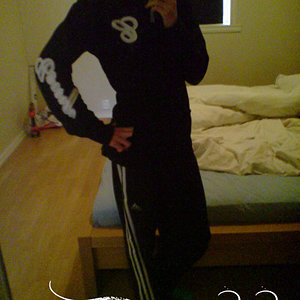 Adidas womens black track suit semi side angle pose