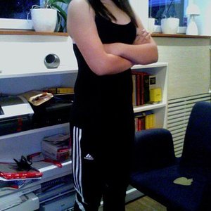 Adidas womens black pants with black tank top arms crossed pose