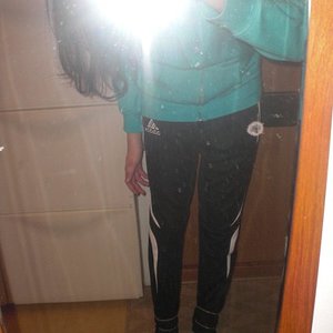 Adidas womens black pants with white stripes front camera flash shot