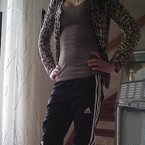 Adidas womens black pants white stripes far logo front hip pose