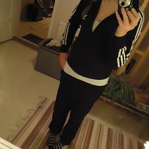 Adidas womens black suit white trip tilted front angle shot