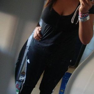 Adidas womens black pants with white stripes tilted front angle shot with black top