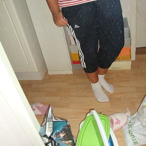 Adidas womens black pants with white stripes tilted angle shot