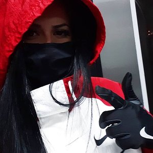 Masked girl showing her shiny nike gloves