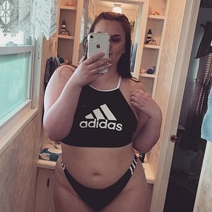 Sexy girl teasing in her adidas swimsuit