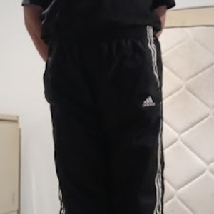 Me wearing my Small Black Adidas Nylon Pants with my hands behind my back 2