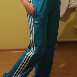 Adidas womens teal pants white stripes leg pose