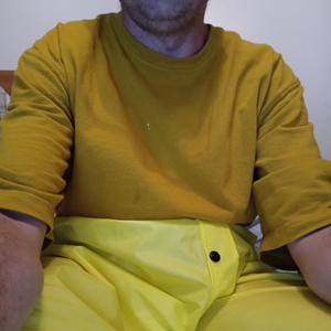 Me lounging around in my bedroom in my new yellow nylon pants (close-up)