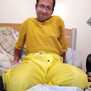 Me lounging around in my bedroom in my new yellow nylon pants (farther away)