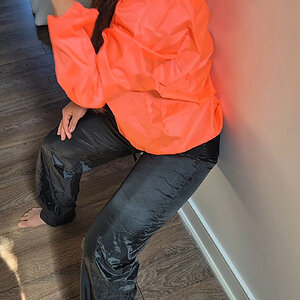 Orange rainjacket with shiny wetlook nylon pants