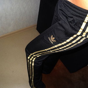 Girl with black/gold adidas pants