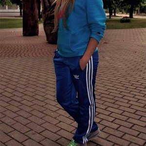 Girl with blue/white adidas pants
