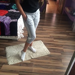 Girl with grey/white adidas pants