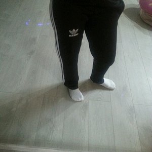 Girl in black/white Adidas pants