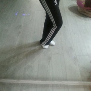 Girl in black/white Adidas pants