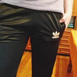 Girl with shiny black adidas pants
