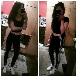 Girl in black/white Adidas pants