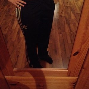 Girl in black/white Adidas pants