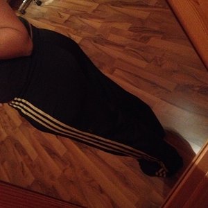Girl in black/white Adidas pants