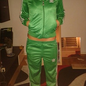 Girl in shiny green Adidas outfit