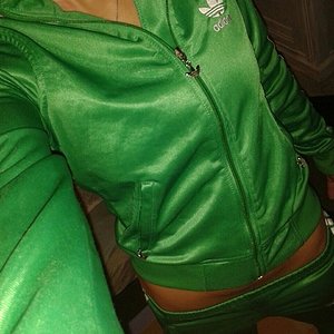 Girl in shiny green Adidas outfit