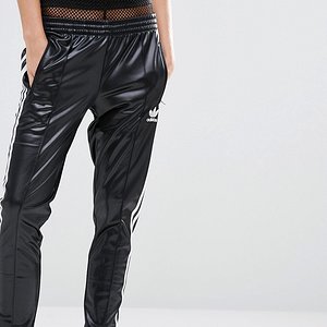 Hot blonde in Adidas Chile pants front close up