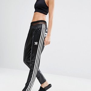 Hot blonde in Adidas Chile pants side view