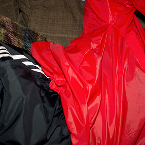 Red K-way pullover and black adidas pants
