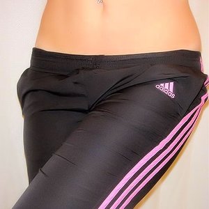 Girl in black and pink Adidas pants