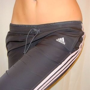 Girl in black and white Adidas pants