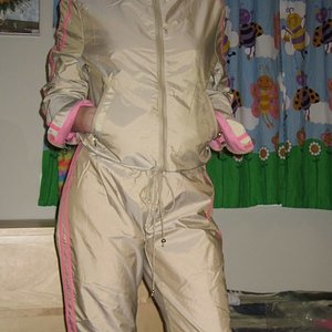 Woman wearing tan and pink shellsuit, front shot