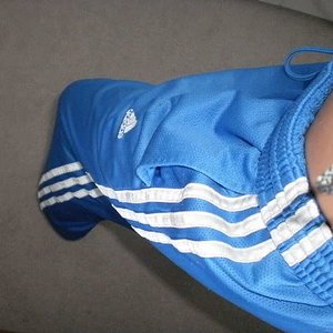 Girl in blue Adidas pants
