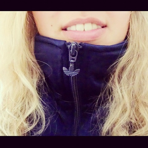 Adidas blue jacket zipped up