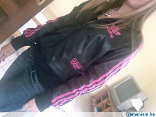 Adidas womans black jacket pink trim tilted angle shot