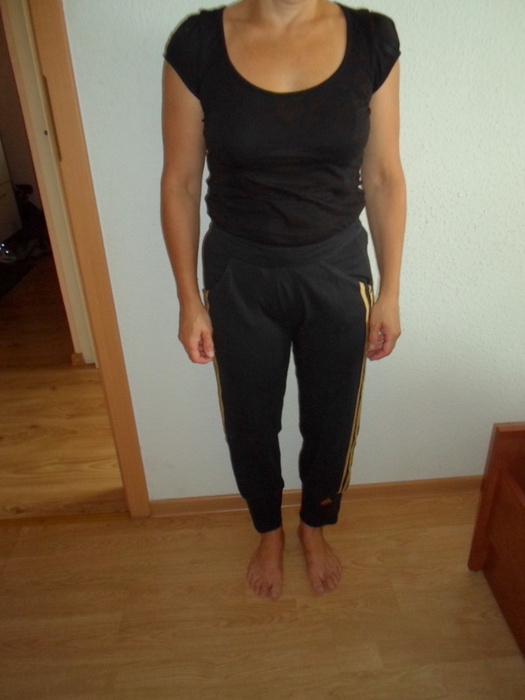 Adidas womans black pants no sleeve black top barefoot front